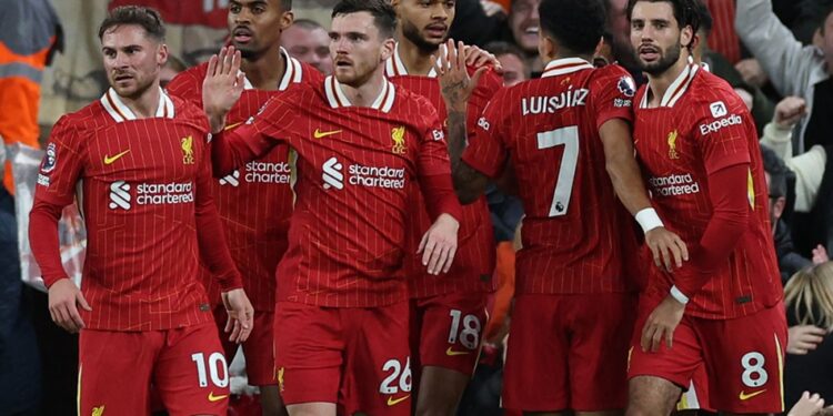Liverpool's Dutch striker #18 Cody Gakpo (C) celebrates with teammates after scoring the opening goal of the English Premier League football match between Liverpool and Manchester City at Anfield in Liverpool, north west England on December 1, 2024. (Photo by Adrian Dennis / AFP) / RESTRICTED TO EDITORIAL USE. No use with unauthorized audio, video, data, fixture lists, club/league logos or 'live' services. Online in-match use limited to 120 images. An additional 40 images may be used in extra time. No video emulation. Social media in-match use limited to 120 images. An additional 40 images may be used in extra time. No use in betting publications, games or single club/league/player publications. / مواعيد مباريات ليفربول القادمة